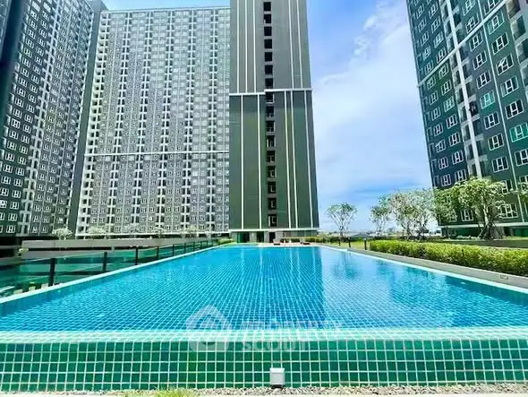 Luxurious high-rise apartment complex with stunning outdoor pool and modern architecture.