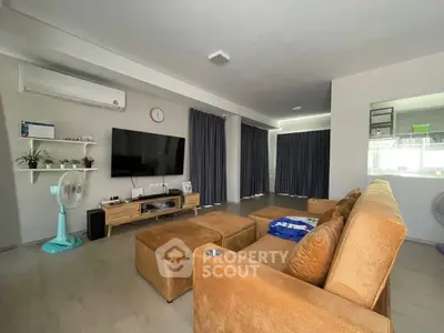 Spacious living room with modern decor and large brown sofa