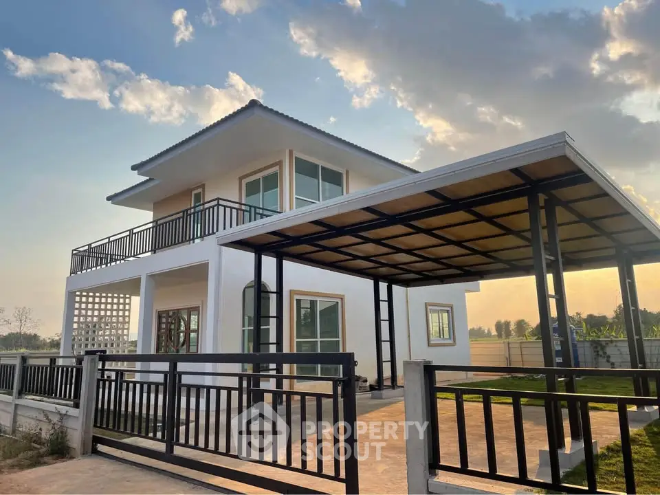 Modern two-story house with spacious carport and sleek design under a clear sky.