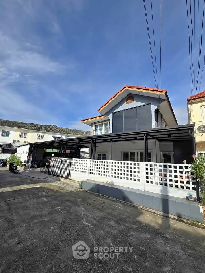 Charming two-story house with modern facade and spacious driveway in a serene neighborhood.