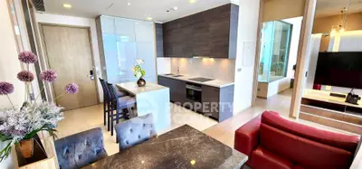 Modern open-layout kitchen and living area with stylish decor and natural light.