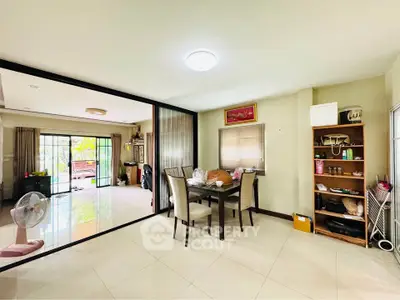 Spacious open-plan living and dining area with sliding glass doors to balcony