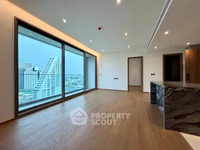 Spacious modern living room with panoramic city view and elegant wooden flooring.