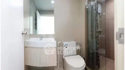 Modern bathroom with sleek fixtures and glass shower enclosure