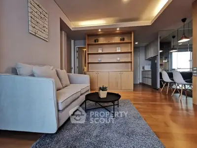Modern living room with cozy sofa and stylish decor in open layout apartment.
