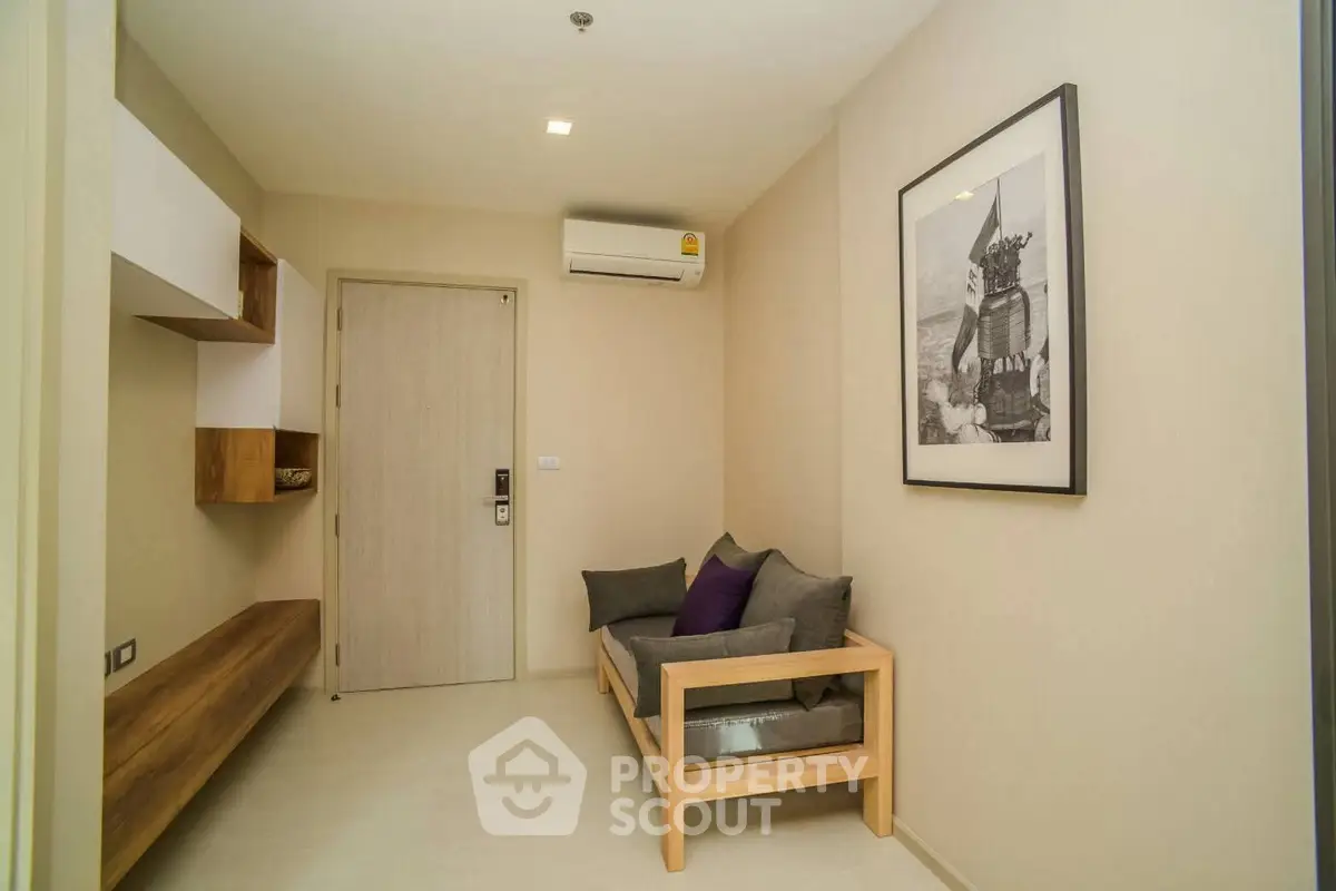 Cozy living room with modern decor and air conditioning, perfect for relaxation.