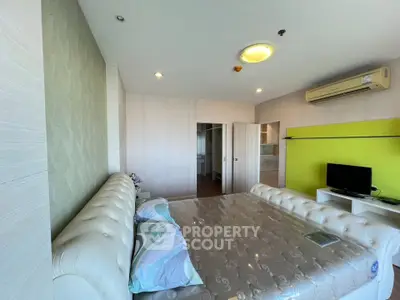 Spacious bedroom with modern decor and air conditioning in a stylish apartment.