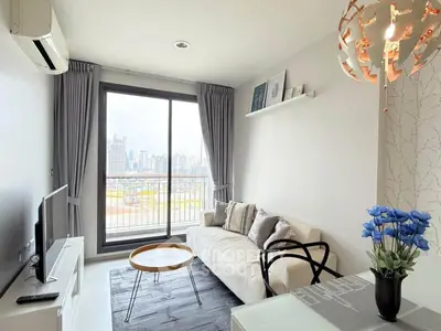 Modern living room with city view, stylish decor, and natural light.