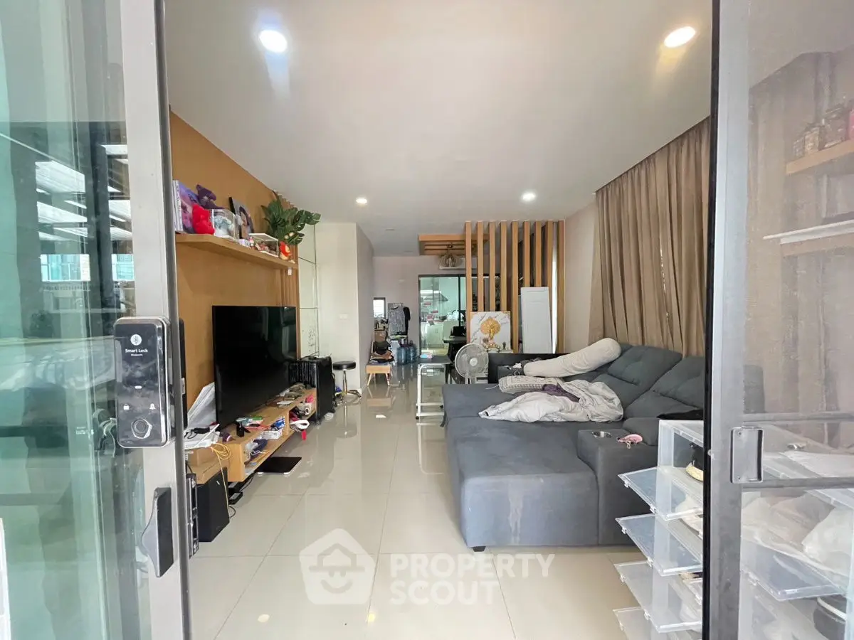 Spacious living room with modern decor and large sectional sofa, perfect for relaxation and entertainment.