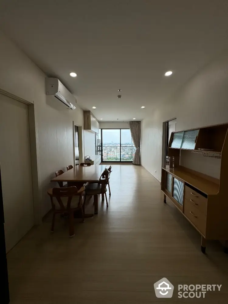 Spacious dining area with modern furniture and city view balcony