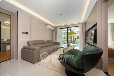 Modern living room with pool view, stylish furniture, and elegant lighting.
