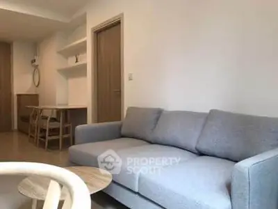 Modern living room with cozy gray sofa and minimalist decor