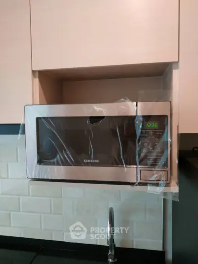 Modern kitchen with built-in microwave and sleek cabinetry