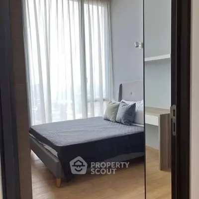 Modern bedroom with large windows and stylish decor in a high-rise apartment.