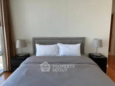 Modern bedroom with elegant decor and ample natural light, featuring a cozy bed and stylish bedside lamps.