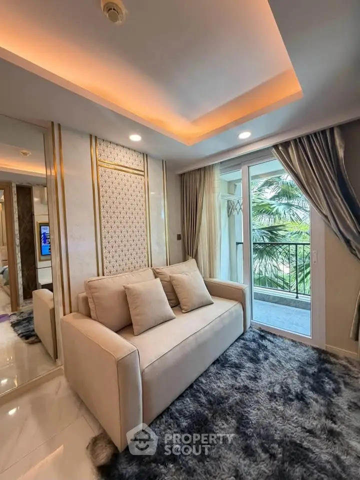 Luxurious living room with elegant decor and balcony view, featuring plush sofa and ambient lighting.