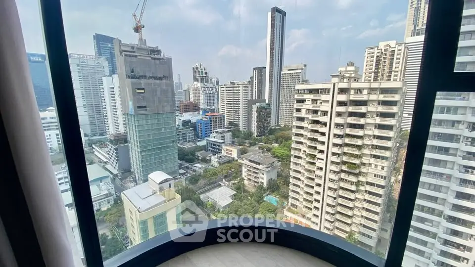 Stunning cityscape view from a high-rise apartment window, showcasing urban skyline and architecture.