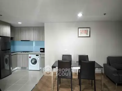 Modern kitchen and dining area with sleek appliances and stylish furniture