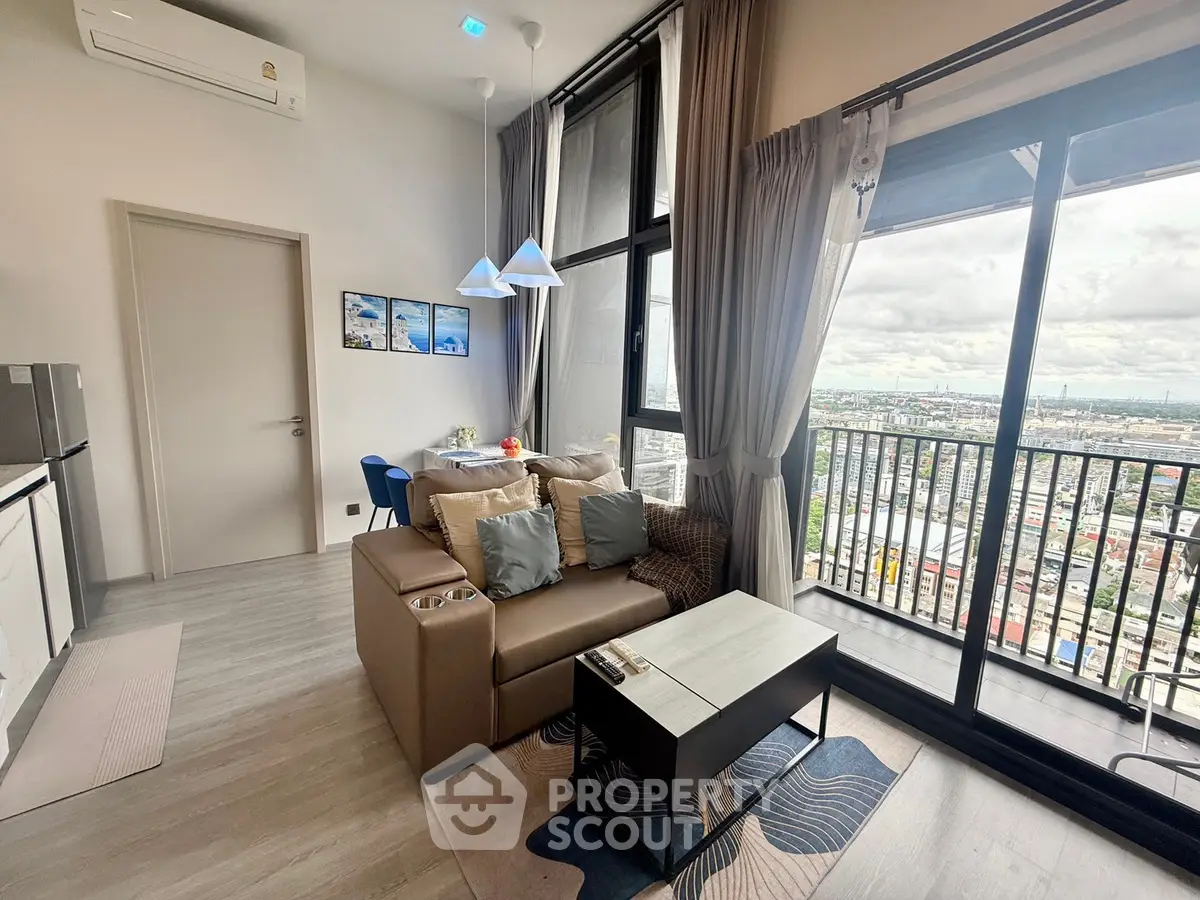 Modern living room with balcony offering stunning city views, featuring cozy seating and stylish decor.