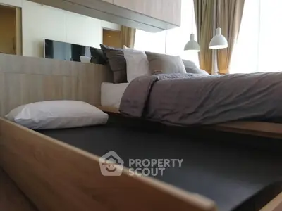 Modern bedroom with sleek wooden bed frame and cozy bedding