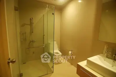 Modern bathroom with glass shower and sleek fixtures in a contemporary home.