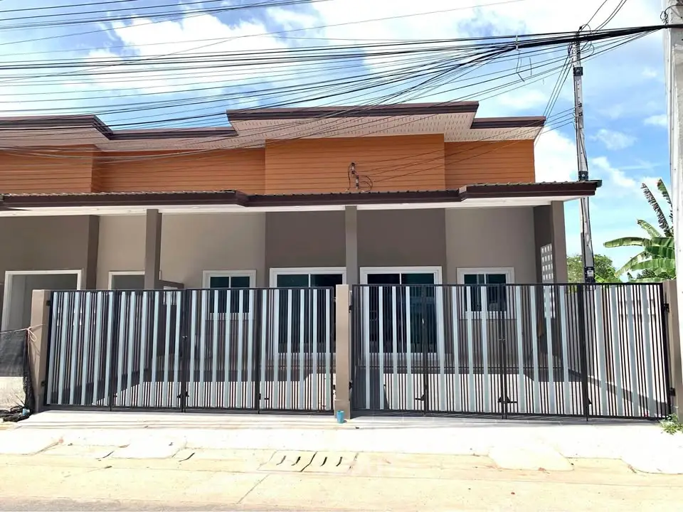 Modern townhouse exterior with gated entrance and sleek design