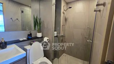 Modern bathroom with glass shower and sleek fixtures