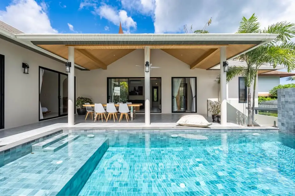 Luxurious villa with private pool and modern outdoor dining area.
