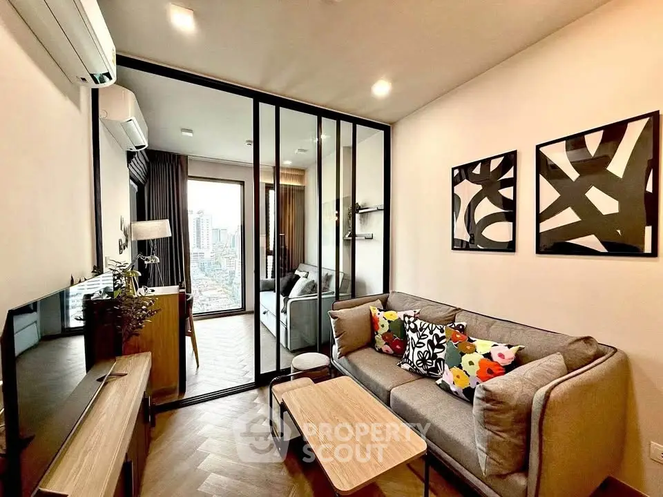 Modern living room with stylish decor and city view in a high-rise apartment.