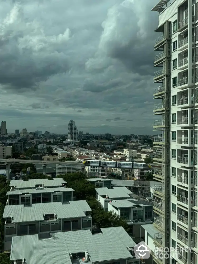 Stunning cityscape view from high-rise apartment with dramatic clouds