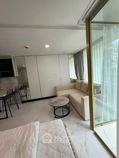 Modern studio apartment with open layout and large windows