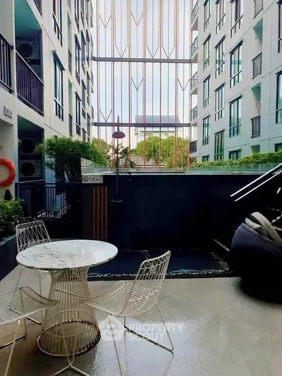 Modern apartment balcony with stylish furniture and city view