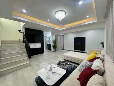 Spacious modern living room with elegant chandelier and stylish decor