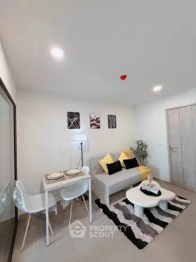 Modern living room with stylish decor and cozy dining area in a contemporary apartment.