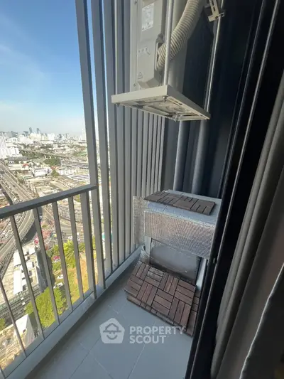 High-rise balcony with city view and air conditioning unit