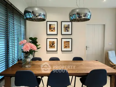 Modern dining room with stylish pendant lights and wooden table