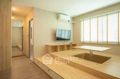Modern minimalist living room with built-in storage and natural light