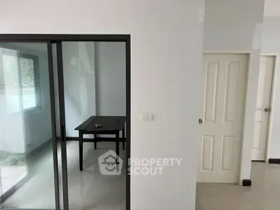 Modern interior with sliding glass door and minimalist design, showcasing potential for customization.