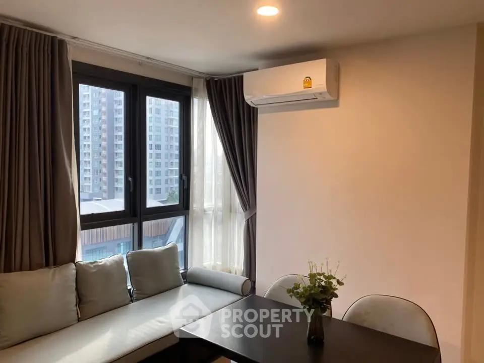 Modern living room with large windows and air conditioning unit