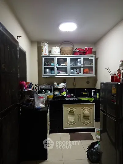 Cozy kitchen with ample storage and modern appliances, perfect for culinary enthusiasts.