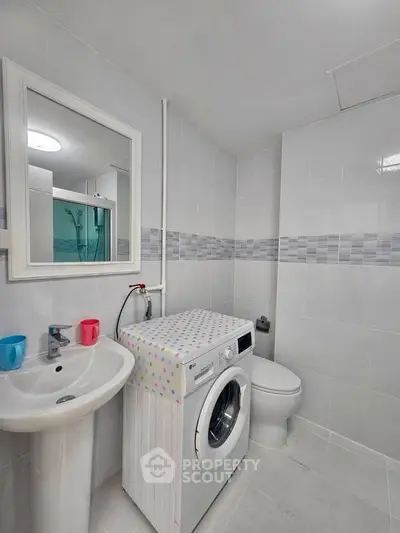 Modern bathroom with washing machine and sleek design