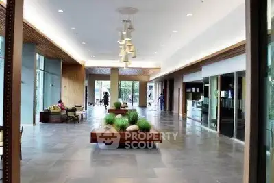 Spacious modern building lobby with stylish decor and ample natural light.