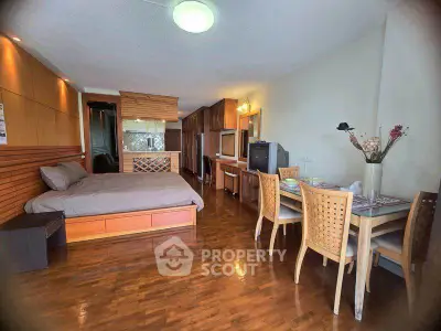 Spacious studio apartment with wooden flooring and modern furnishings