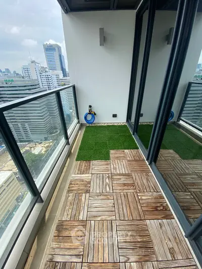 Modern balcony with city view, wooden flooring, and artificial grass in high-rise building.