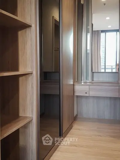 Spacious modern bedroom with wooden flooring and built-in wardrobe