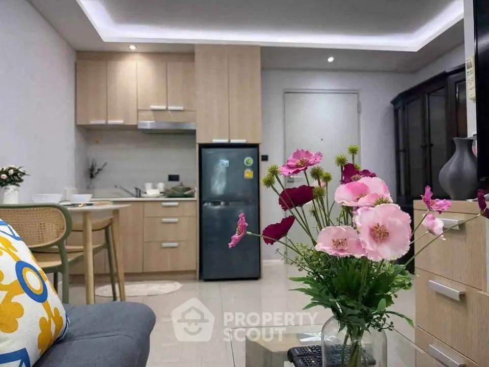 Modern kitchen and living area with stylish decor and vibrant flowers
