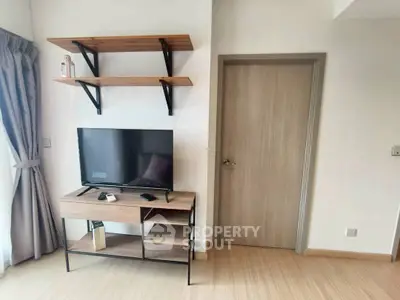 Modern living room with TV stand and wall shelves, minimalist design.