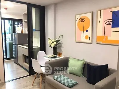 Modern living room with stylish decor and open kitchen layout in a cozy apartment.