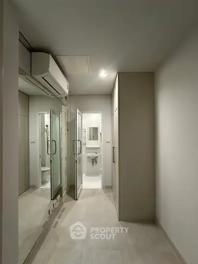 Modern bathroom with sleek design and mirrored storage cabinets