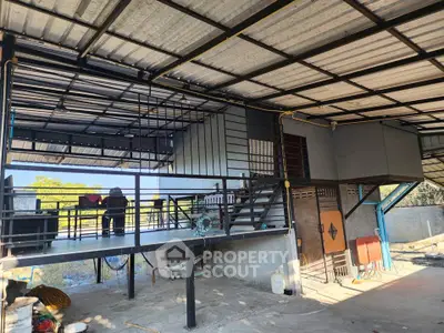 Modern industrial-style home with open balcony and metal framework, perfect for creative living.